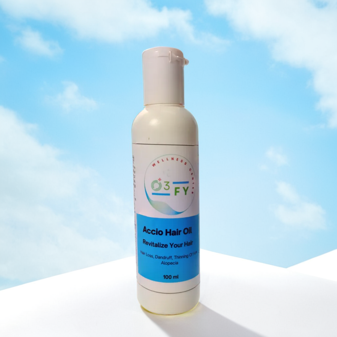 Accio Hair Oil bottle placed on a white surface with soft, fluffy cloud accents, symbolizing its light, natural, and nourishing care for healthy hair